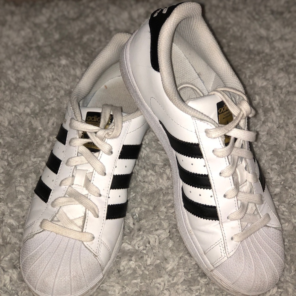 White and black adidas superstar shoes